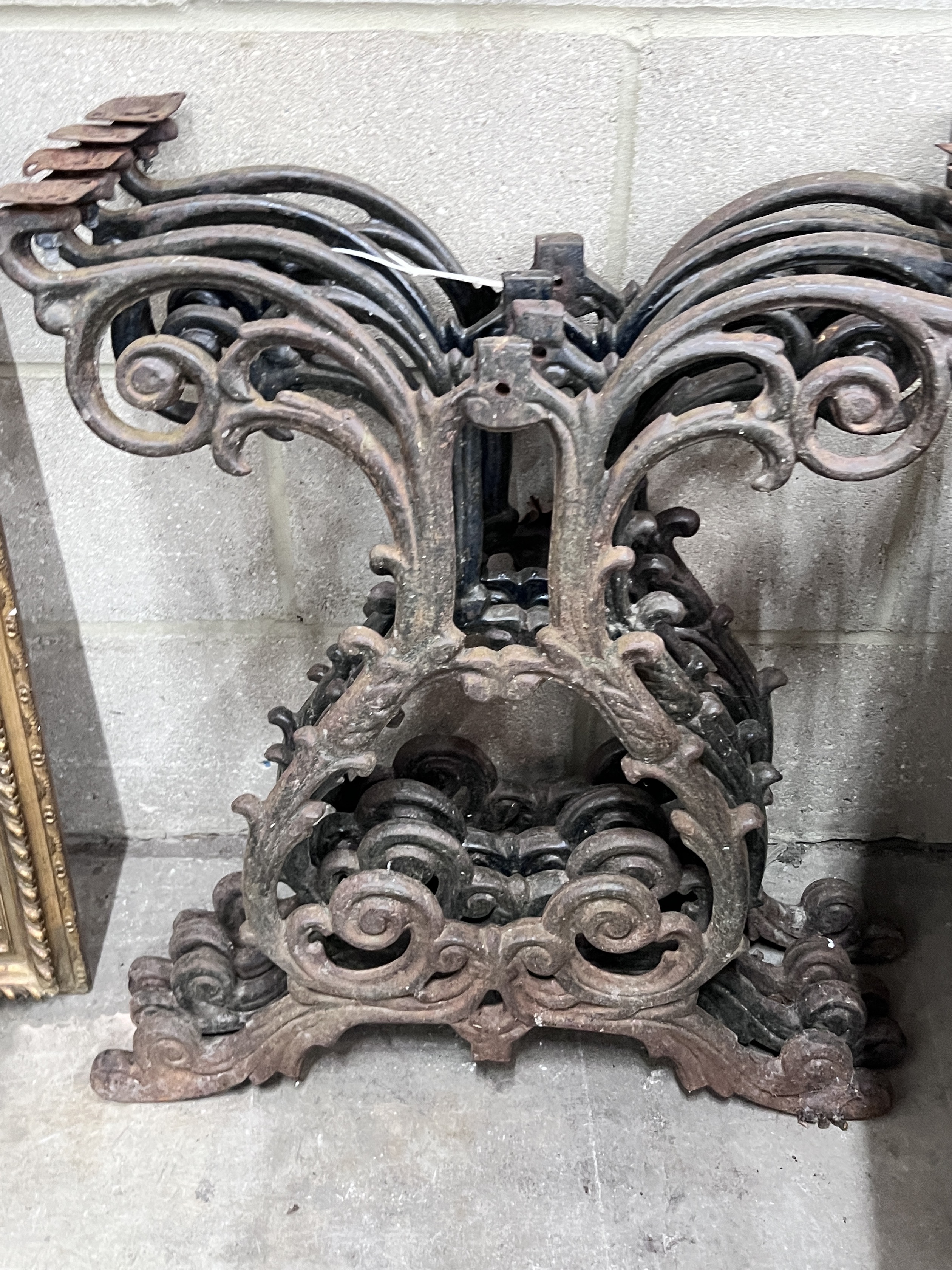 A set of four Victorian style cast iron table supports, width 54cm, height 66cm